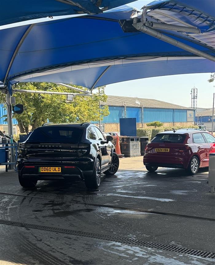 Cars queuing under the blue canopy at Springwood Hand Car Wash
