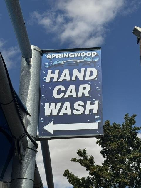 Springwood Hand Car Wash roadside sign pointing into the industrial estate